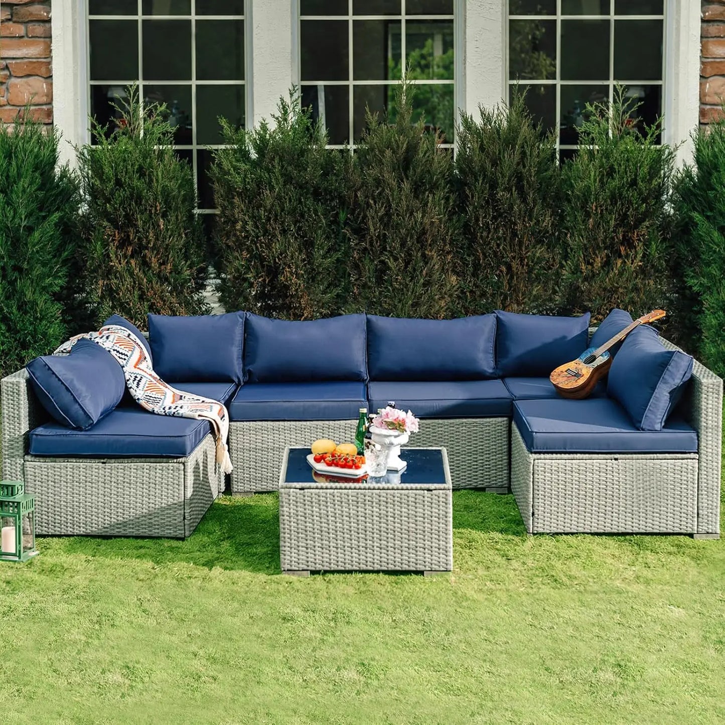 Brown rattan sectional with glass-top table