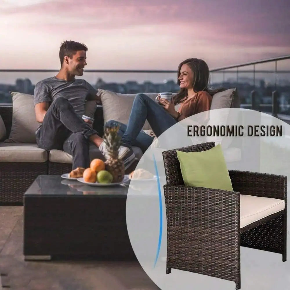Wicker patio furniture set with cushions and glass table